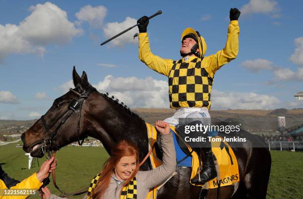 Paul Townend celebrates victory on Al Boum Photo after they won the Gold Cup during day four of the Cheltenham National Hunt Racing Festival at...