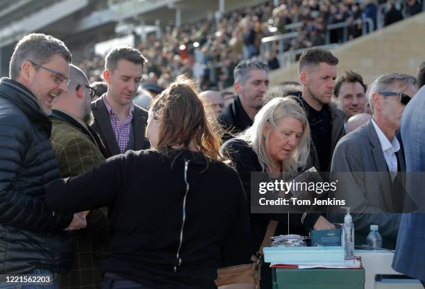 Bookmakers handing out money during day four of the Cheltenham National Hunt Racing Festival at Cheltenham Racecourse on March 13th 2020 in...