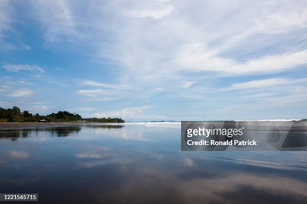 Clouds reflect on the wet sand of a beach on October 1, 2012 in Utria National Park, Colombia. The Utria National Park lies in the Pacific northern...
