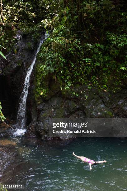 Woman swims in a natural pool by a waterfall on October 1, 2012 in Utria National Park, Colombia. The Utria National Park lies in the Pacific...