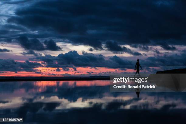Man walks on the beach during sunset on October 1, 2012 in Utria National Park, Colombia. The Utria National Park lies in the Pacific northern coast...