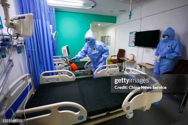 Medical workers disinfect a ward after the last two COVID-19 patients are discharged from Xiaotangshan Hospital on April 28, 2020 in Beijing, China....