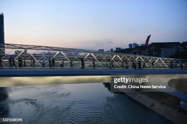 People walk on the Wuchazi Bridge, which is designed with the concept of 'Mobius Strip' on April 27, 2020 in Chengdu, Sichuan Province of China.