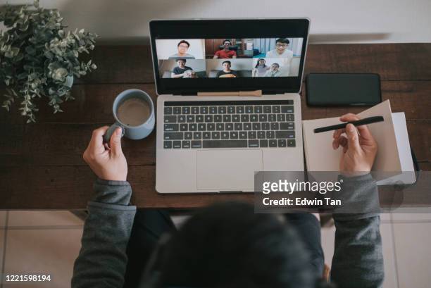 an asian chinese male working at home using laptop video conference call meeting with headset - organised group stock pictures, royalty-free photos & images