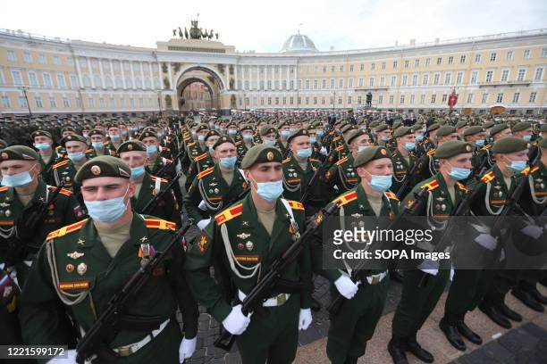 Russian military servicemen wearing face masks take part in a general rehearsal of the Victory Day parade at the Dvortsovaya Square in front of the...