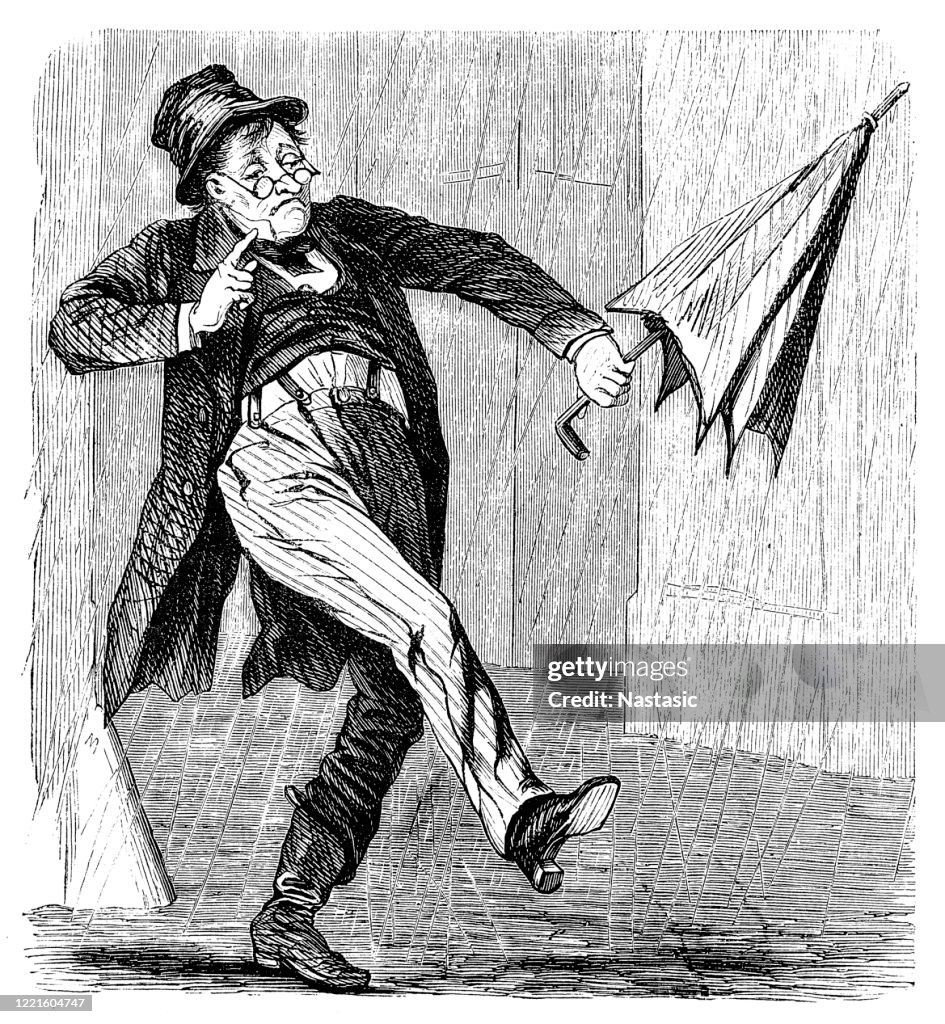Man with closed umbrella walking on a rain