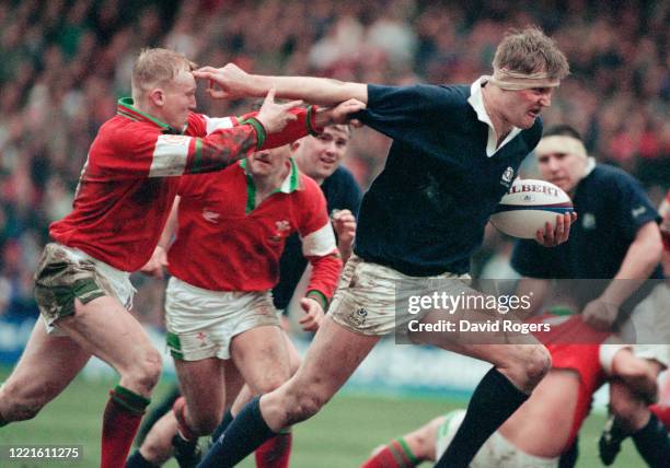 Scotland player Doddie Weir hands off the attempted tackle of Neil Jenkins during the Five Nations match between Scotland and Wales on March 4, 1995...