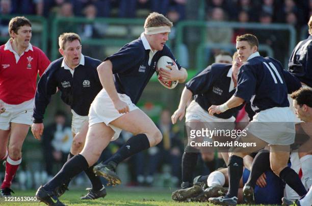 Scotland player Doddie Weir makes a run in an International match against Italy watched by scrum half Gary Armstrong and wing Craig Joiner on January...