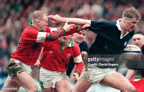 Scotland player Doddie Weir hands off the attempted tackle of Neil Jenkins during the Five Nations match between Scotland and Wales on March 4, 1995...