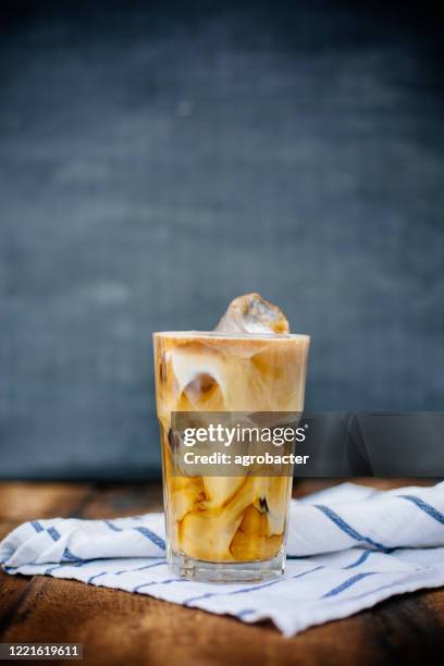 prepairing iced latte on wooden table - iced coffee cup stock pictures, royalty-free photos & images