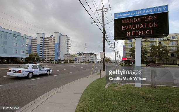 Police car patrols the streets on August 26, 2011 in Ocean City, Maryland. Ocean City Mayor Rick Meehan has ordered a mandatory evacuation for...