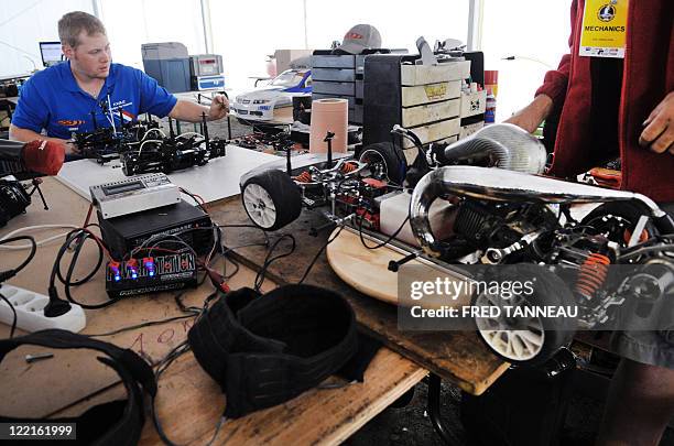 Auto mechanics prepare radio controlled cars at 1/5th scale prior to the race, in August 26, 2011 during the 1/5 RC World Championships, in the...