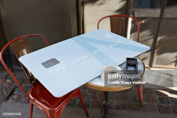large credit card on table at cafe - cup sizes stock pictures, royalty-free photos & images