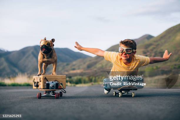 travelling boy and his dog - perro fotografías e imágenes de stock