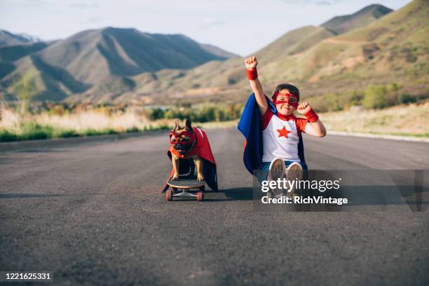 superhero dog and his boy - dog skateboard stock pictures, royalty-free photos & images