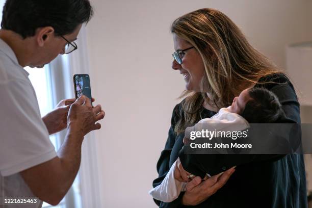 Stamford Elementary school teacher Luciana Lira holds baby Neysel, then 2 1/2 weeks, while showing the newborn for the first time to his immigrant...
