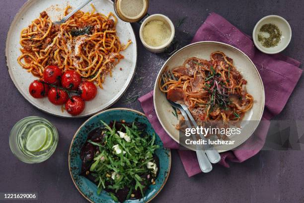 italian pasta with parma ham and roasted beetroot and feta salad with arugula - pancetta stock pictures, royalty-free photos & images