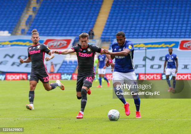 Nathaniel Mendez-Laing of Cardiff City FC and Ezgjan Alioski of Leeds United during the Sky Bet Championship match between Cardiff City and Leeds...