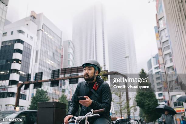 Bicycle Messenger Checking His Phone