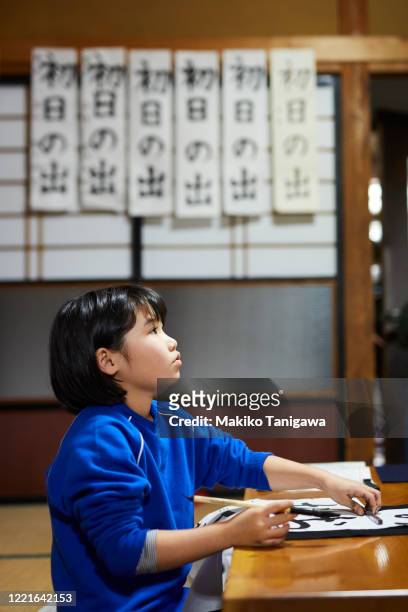 japanese girl doing kakizome - japanese calligraphy stock pictures, royalty-free photos & images