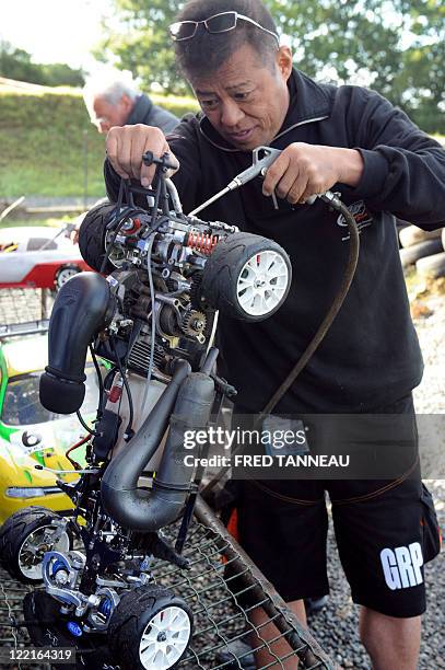 Japanese Kato Naohiko cleans up his car at 1/5th scale, in August 26, 2011 during the 1/5 RC World Championships, in the Hanvec circuit in Brest,...