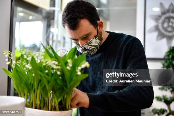 Florist is seen preparing Lily of the Valley orders in celebration of Labor Day during the Coronavirus pandemic on April 28, 2020 in La Celle Saint...