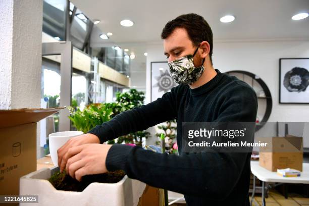 Florist is seen preparing Lily of the Valley orders in celebration of Labor Day during the Coronavirus pandemic on April 28, 2020 in La Celle Saint...