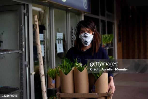 Florist is seen preparing Lily of the Valley orders in celebration of Labor Day during the Coronavirus pandemic on April 28, 2020 in La Celle Saint...