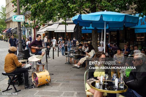 Band plays music in the streets of Paris in front of a restaurant during the French midsummer Festival of Music "Fete de la musique" , on June 21 as...