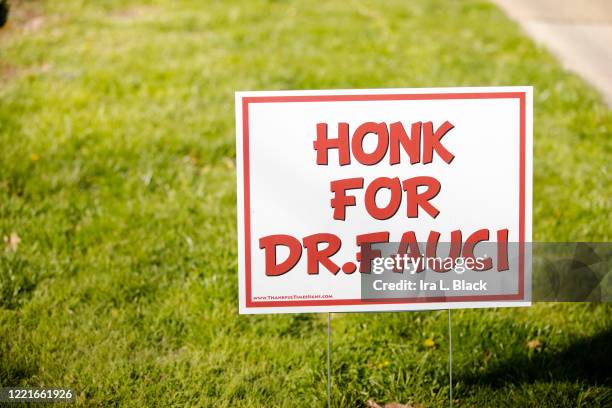 Sign on a lawn says, "Honk for Dr. Fauci" to show support for Dr. Anthony S. Fauci, M.D., director of the National Institute of Allergy and...