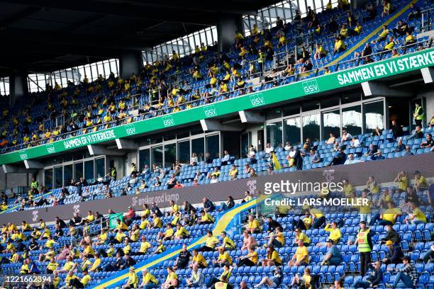 Spectators sit in the stands during the Danish Superliga football match at Broendby Stadium between Broendby IF and FC Copenhagen, on June 21, 2020....