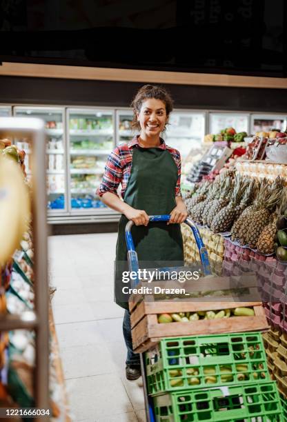 essential latina worker bringing delivery parcels for distribution during lockdown - essential services employees stock pictures, royalty-free photos & images