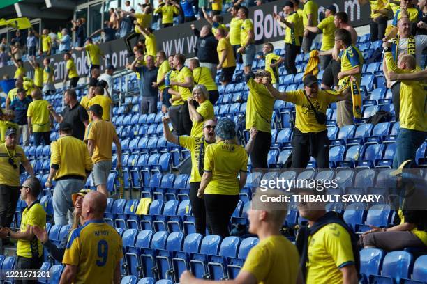Brondby fans observing social distancing celebrate their team scoring against FC Copenhagen at Brondby stadium, Denmark on June 21, 2020. - The first...