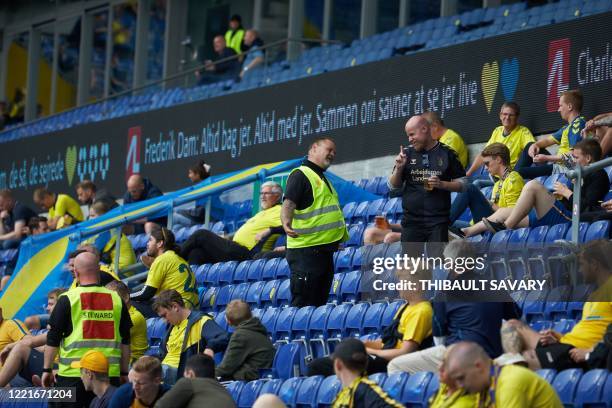 Steward speaks with a Brondby football fan attending a match against FC Copenhagen at Brondby stadium, Denmark on June 21, 2020. - The first tier...