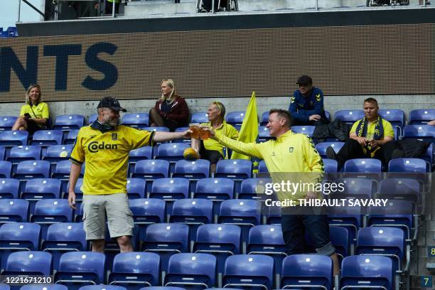 Brondby football fans partly observic social distancing attend a match against FC Copenhagen at Brondby stadium, Denmark on June 21, 2020. - The...