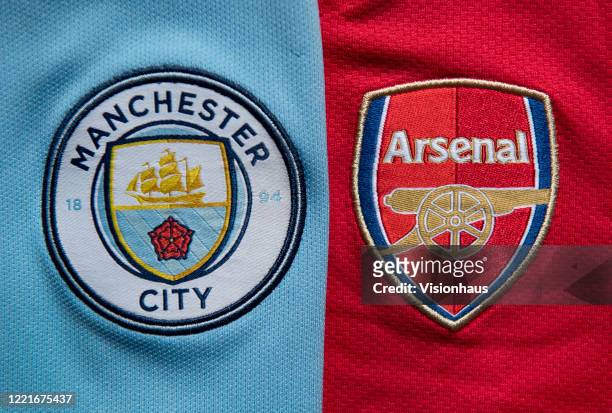 The Manchester City and Arsenal club crests on first team home shirts on April 24, 2020 in Manchester, England