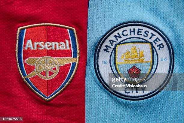 The Manchester City and Arsenal club crests on first team home shirts on April 24, 2020 in Manchester, England