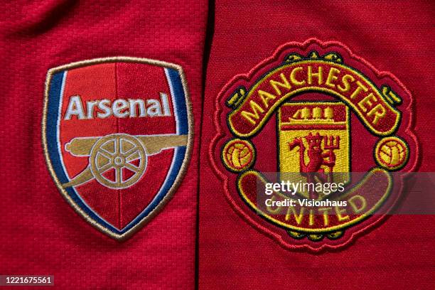 The Manchester United and Arsenal club crests on home shirts on April 24, 2020 in Manchester, England