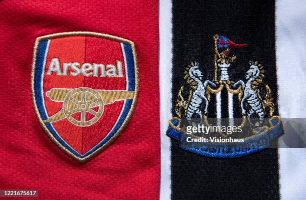 The Arsenal and Newcastle United club crests on home shirts on April 24, 2020 in Manchester, England