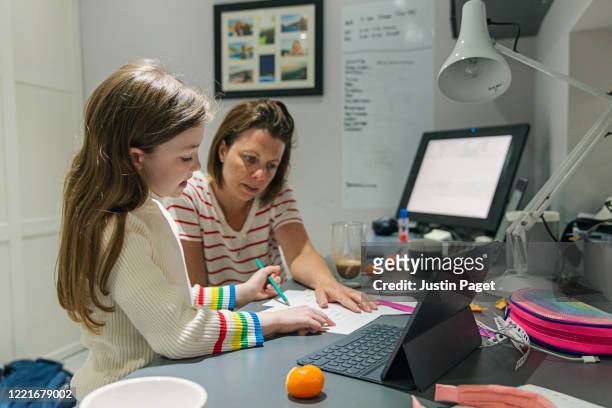 woman helping daughter with her home schooling - home school stock pictures, royalty-free photos & images
