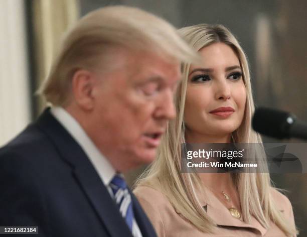 White House advisor Ivanka Trump listens to her father U.S. President Donald Trump deliver remarks on supporting small businesses through the...