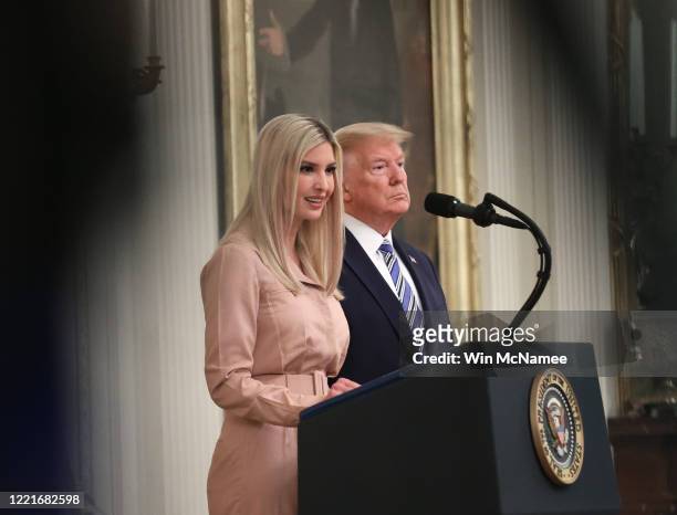 White House advisor Ivanka Trump speaks while her father U.S. President Donald Trump listens on supporting small businesses through the Paycheck...
