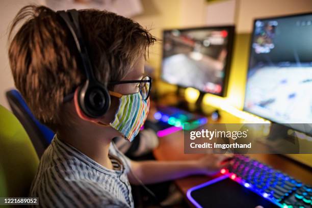 kids playing multiplayer online games using desktop pc - multiplayer online game stock pictures, royalty-free photos & images