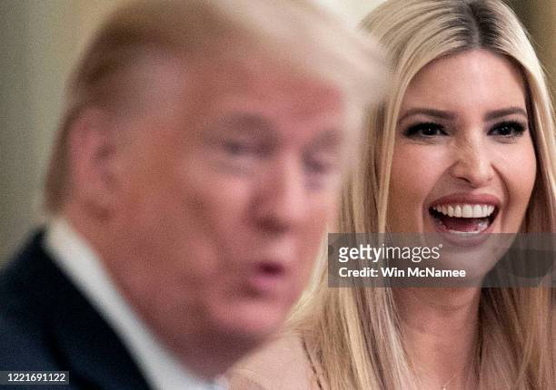 Ivanka Trump laughs as her father, U.S. President Donald Trump, speaks to a small business owner during an event on supporting small businesses...