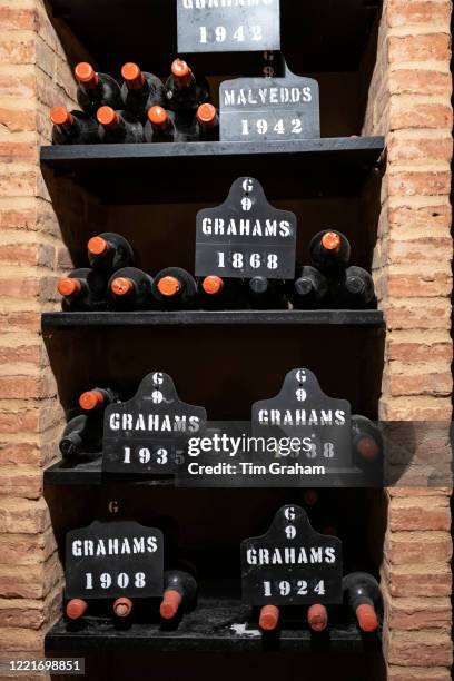 Bottles of vintage port in racks at wine cellars of Graham's Port Lodge in V|la Nova de Gaia in Porto, Portugal.