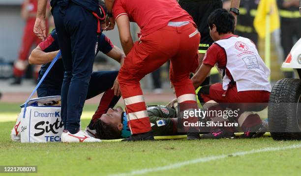 Fabio Pisacane of Cagliari Calcio leaves the pitch with an injury during the Serie A match between AS Roma and Cagliari Calcio at Stadio Olimpico on...
