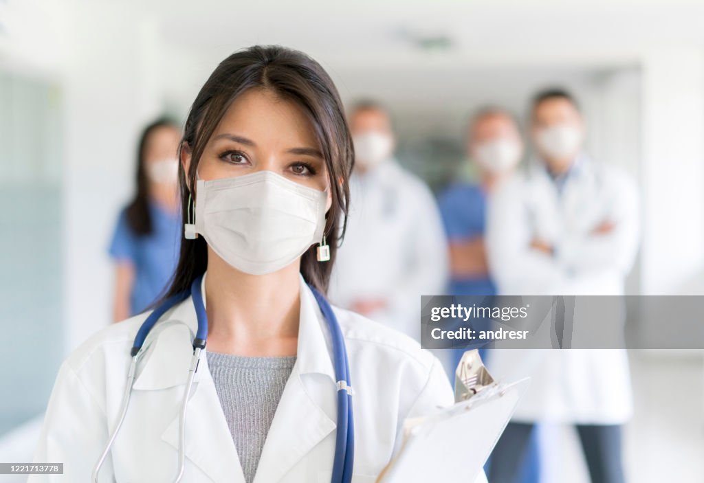 Doctor working at the hospital wearing a facemask to avoid COVID-19