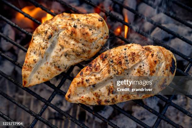 video clip of juicy seasoned chicken breasts, pollo asado on a hot charcoal grill - grilled chicken stock pictures, royalty-free photos & images