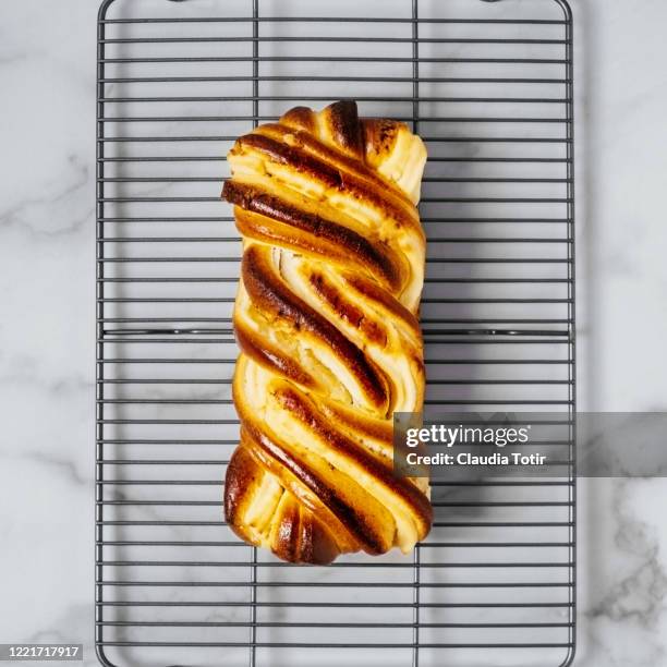 brioche cream cheese swirl on cooling rack on white background - brioche stock pictures, royalty-free photos & images