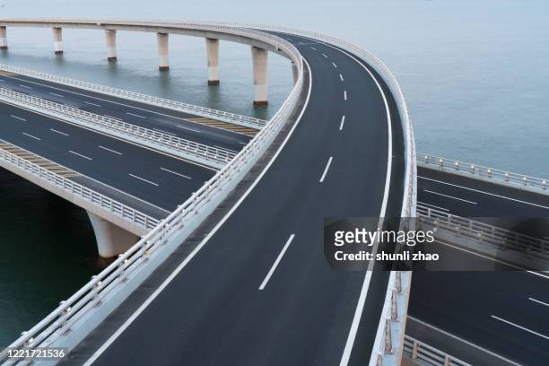 qingdao jiaozhou bay cross-sea bridge - curve road fast stock pictures, royalty-free photos & images